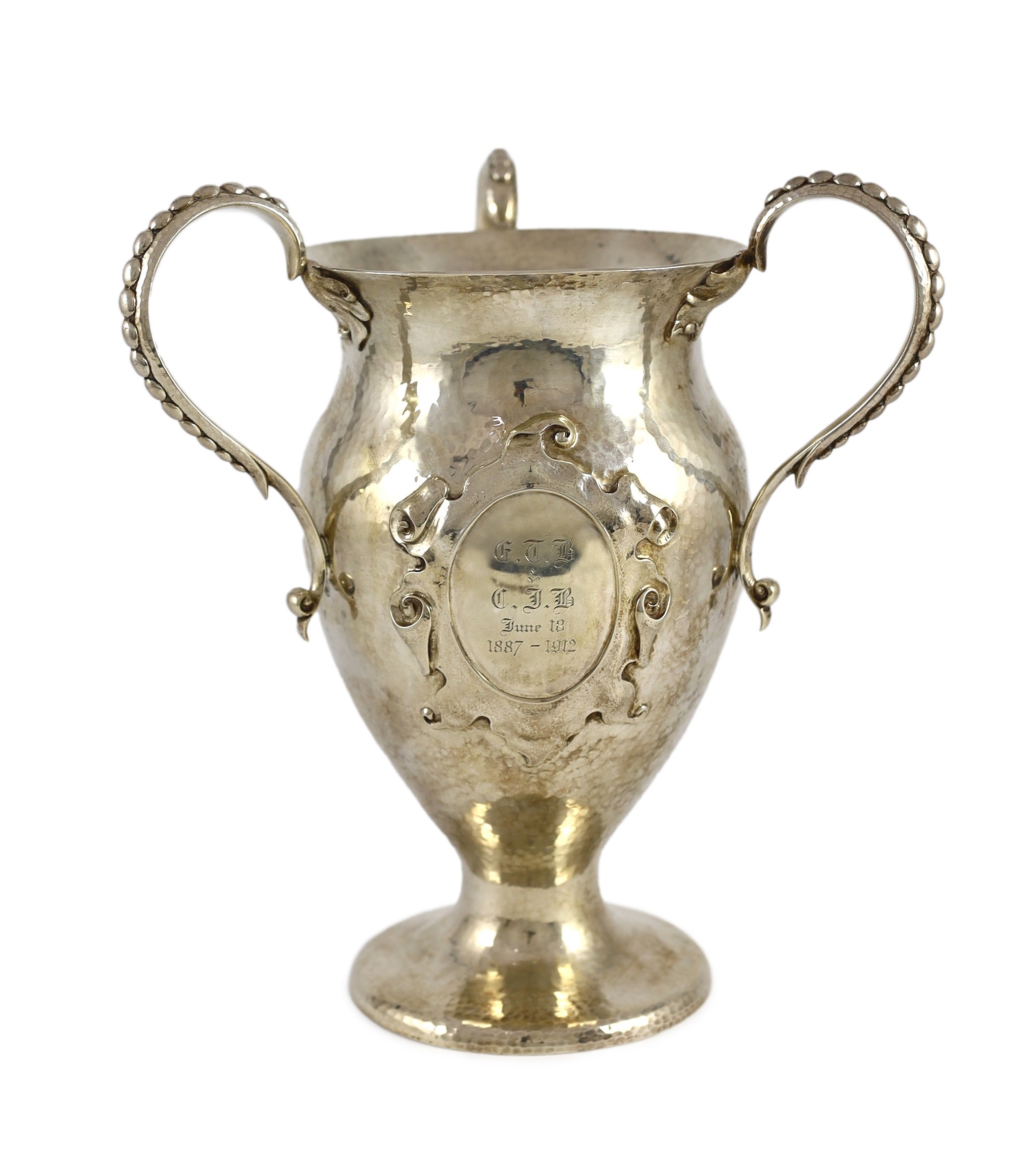 A George V Arts and Crafts planished silver three handled pedestal vase, by Holland, Aldwinckle & Slater